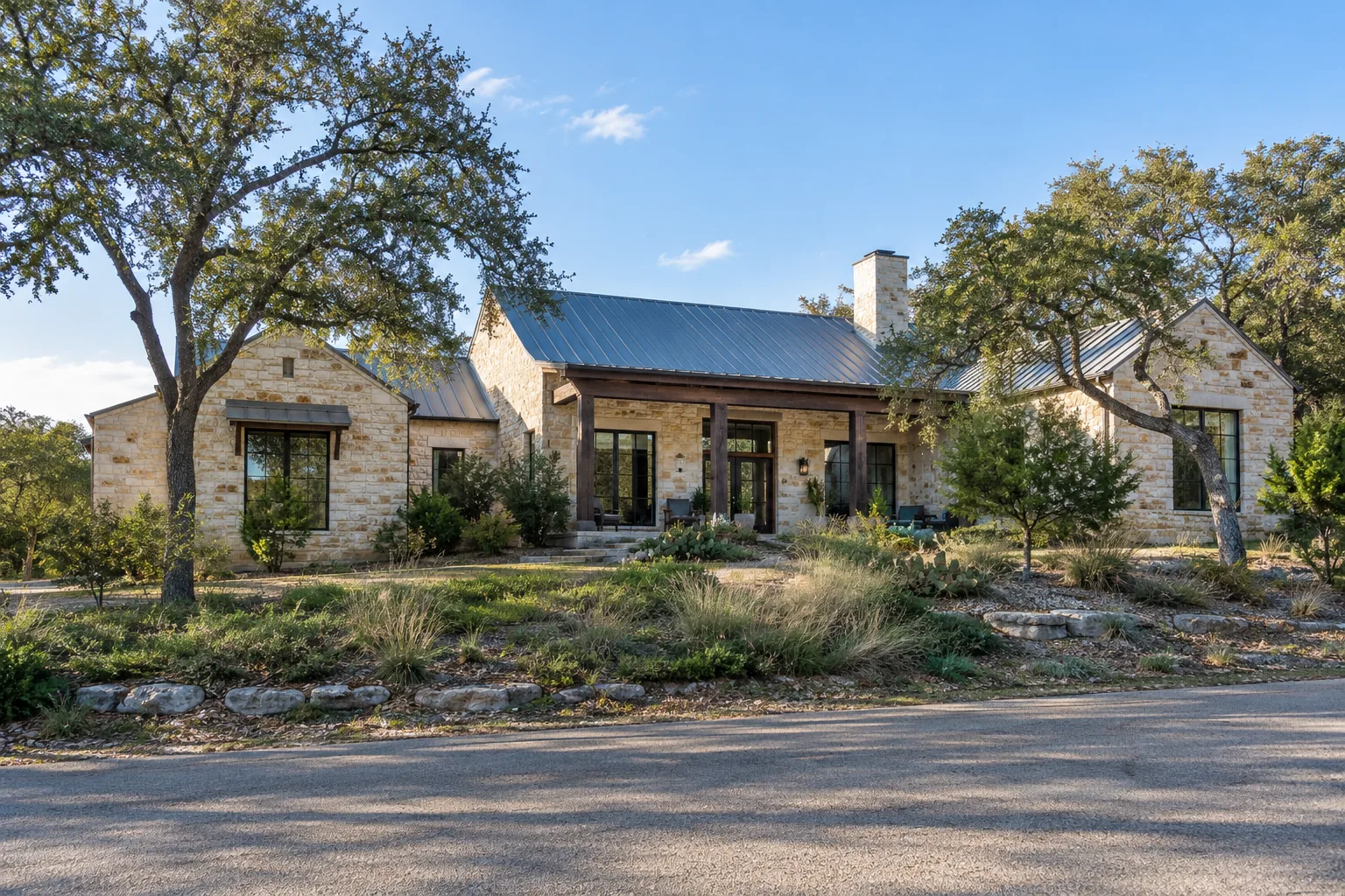 Limestone Hill Country style home with a metal roof on a sloping lot in Austin, TX